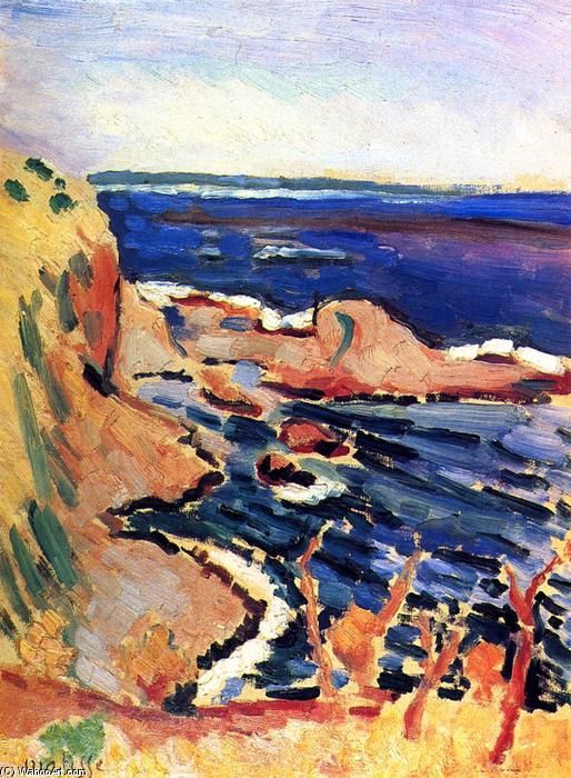 A Fauvist seascape by Henri Matisse showing an orange-ochre cliff descending into a deep blue bay, with white foam threading around coral rocks, pale violet sky above, and red-brown shrubs in the bright yellow foreground, painted in broad, saturated strokes.