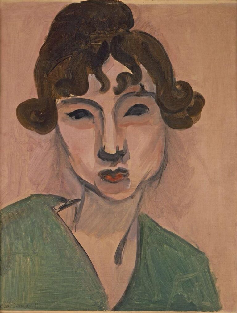 A head-and-shoulders portrait by Henri Matisse of a young woman with dark curled hair, compact red lips, and a deep green shawl, set against a pale rose background; strong black contours, simplified planes, and broad brushstrokes give the modern image a poised, intimate clarity.