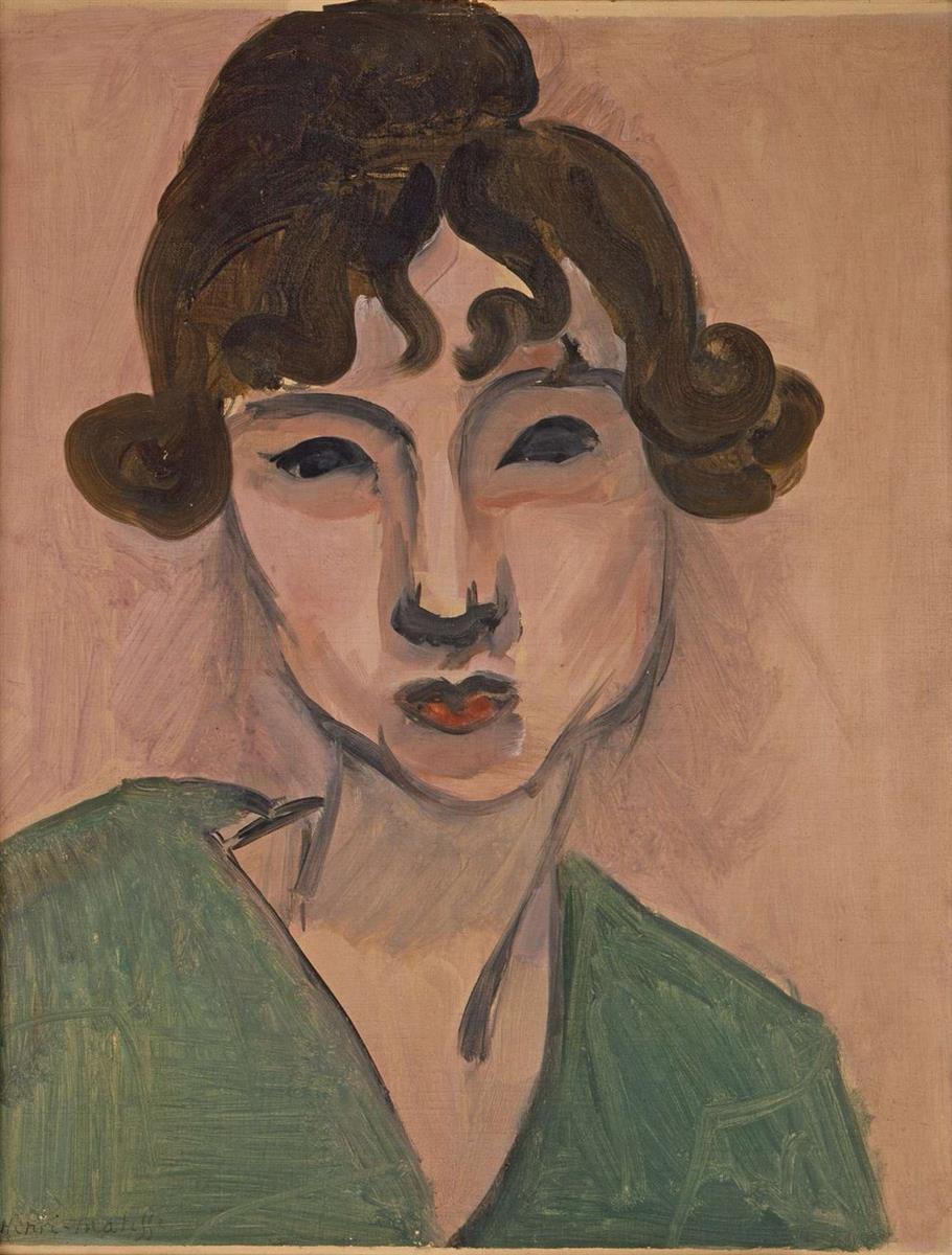 A head-and-shoulders portrait by Henri Matisse of a young woman with dark curled hair, compact red lips, and a deep green shawl, set against a pale rose background; strong black contours, simplified planes, and broad brushstrokes give the modern image a poised, intimate clarity.