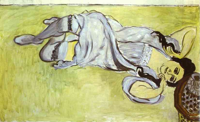 Overhead view of a woman in a pale lilac chemise and gray stockings reclining across a flat green ground, her arms looping near her head; a small cup and saucer rest on a tray by her face. Bold black contours, minimal modeling, and a calm chartreuse atmosphere characterize Matisse’s 1917 portrait “Laurette with a Coffee Cup.”