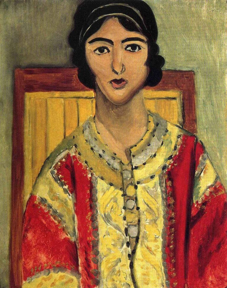 A frontal portrait by Henri Matisse of Lorette seated against a green wall, a golden chair back behind her, wearing a richly colored red dress with a broad yellow embroidered panel; dark outlines define her calm face and the garment’s trim, creating a flat yet luminous, patterned composition.