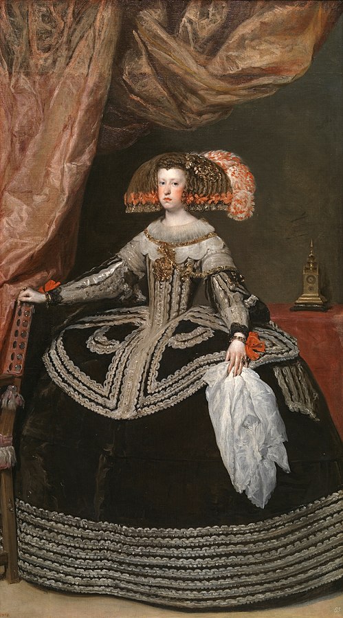 Queen Mariana seated frontally in a vast black, silver-trimmed dress with orange bows, one hand on a studded chair and the other holding a white handkerchief; a rose curtain swells above and a small gilded object sits on a table against a dark wall.