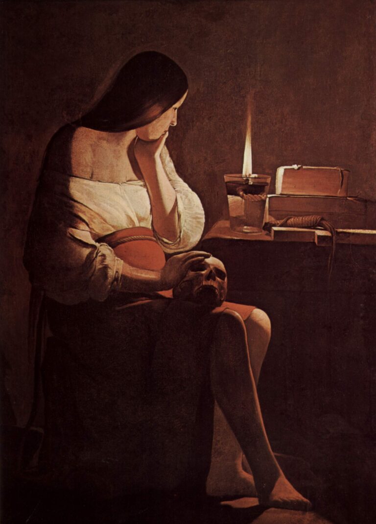 Night scene of Mary Magdalene seated in profile beside a clear oil lamp; she props her chin with one hand while the other rests on a skull on her knee, books and a coiled cord on the table, warm lamplight modeling her white blouse and bare calf against a deep brown interior.