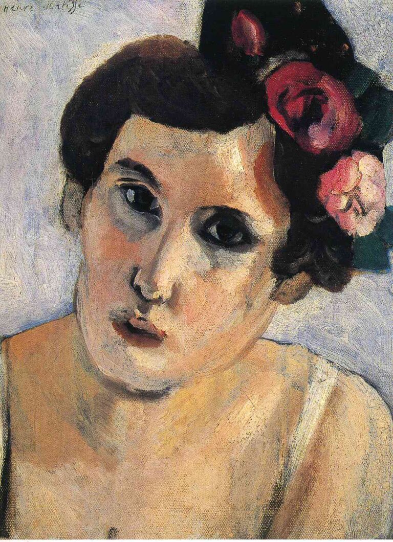 Close view of a woman’s head against a pale lavender background; face tilted slightly left with dark eyes and soft modeling in warm ochres; cluster of red and pink roses tucked into dark hair on the right; simplified features, visible brushwork, and calm Mediterranean light.