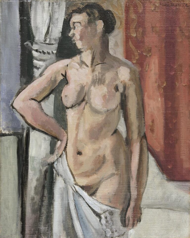 Three-quarter standing nude in a shallow interior, head turned left, left hand on hip, right hand holding a white drape; cool grey column and curtain at left, warm red patterned hanging at right; soft, painterly flesh tones with dark brush-drawn contours characteristic of Matisse, 1919.