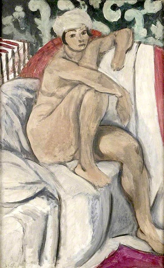 Seated nude with white headwrap on a sofa of white drapery; one arm draped over the back, one knee raised, with a dark arabesque panel behind and two crimson accents at right and lower corner, painted in soft grays, warm flesh tones, and clear contours.