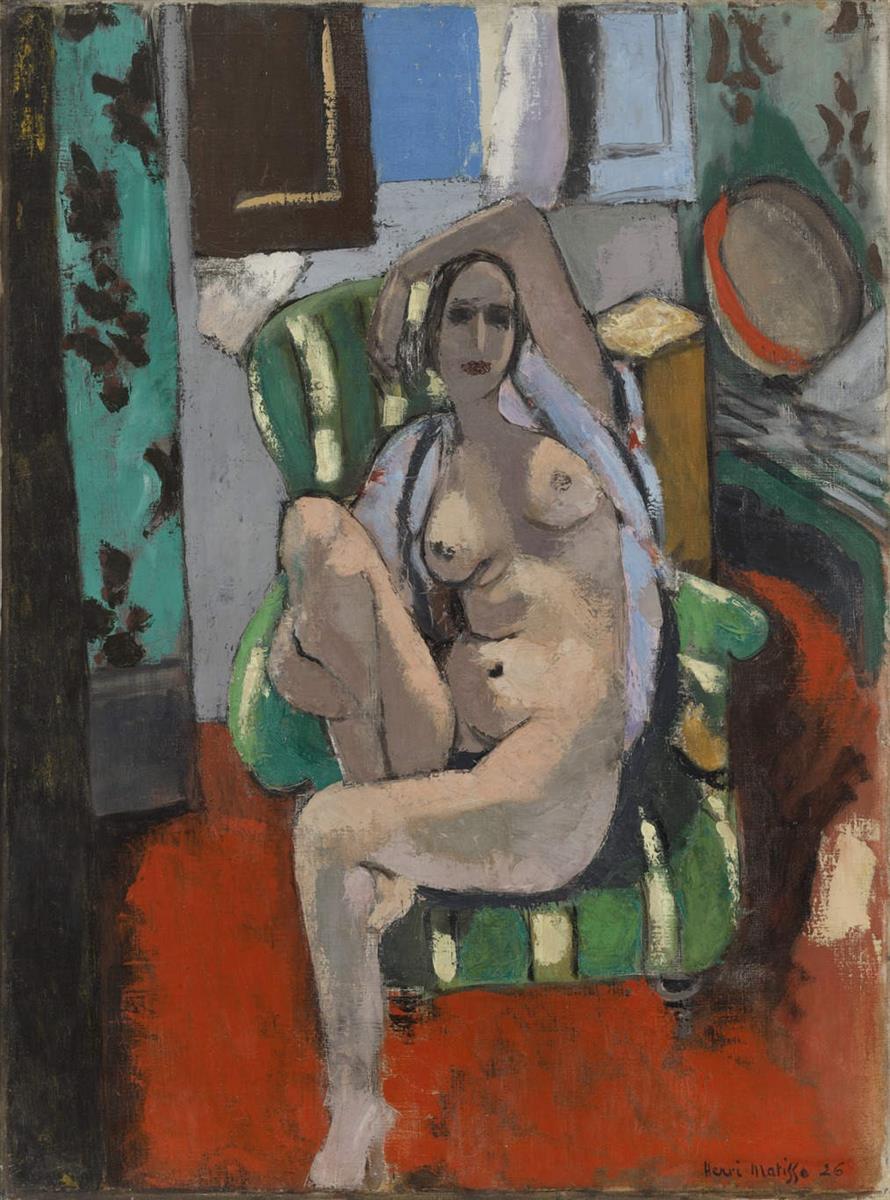 A nude woman reclines and twists in a green-striped armchair within a patterned interior; a red floor dominates the foreground, blue and teal window panels cool the background, and a tan-red tambourine rests at right, painted by Henri Matisse in 1925.