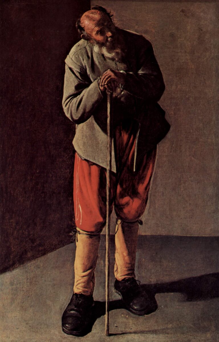 An elderly man stands in a corner, leaning on a long walking stick; he wears a gray jacket, red breeches, pale gaiters, and black shoes, lit from the right against dark and light walls, his head gently bowed.