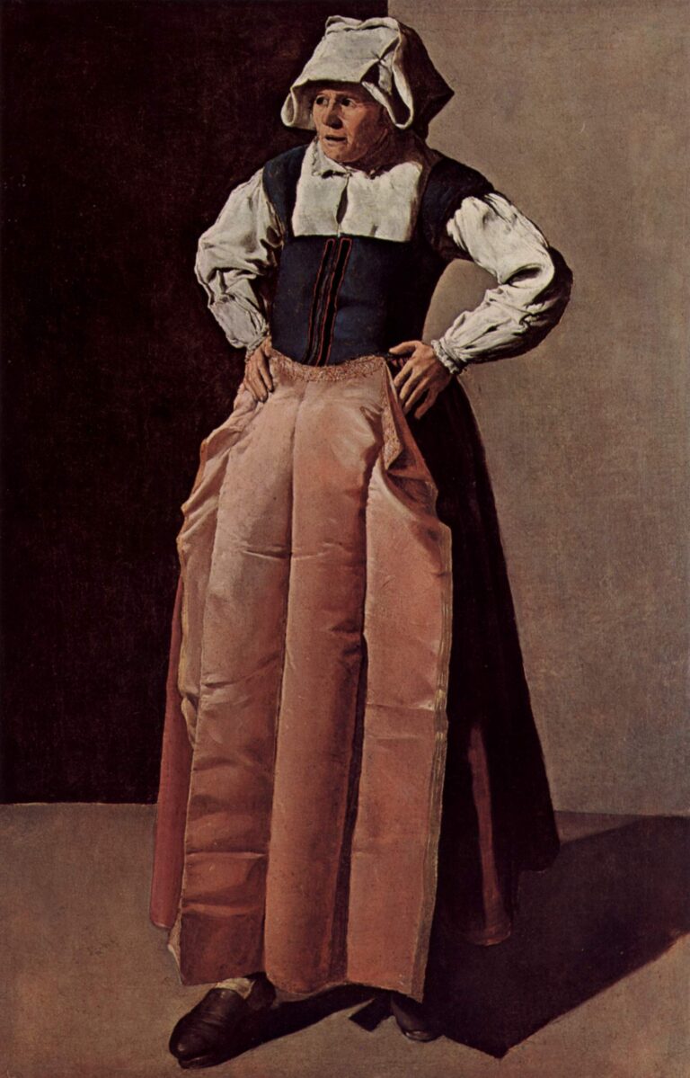 An elderly woman stands in a corner with hands on her hips, wearing a white cap and collar, dark bodice, and a long salmon-rose apron; cool light from the right models her figure against a dark left wall and a pale right wall.