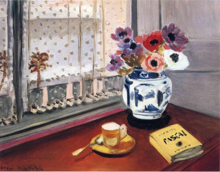 A polished table by a window holds a yellow book titled “Pensées,” a small ochre cup and saucer with a spoon, and a blue-and-white porcelain vase of anemones; a lace curtain filters light and reveals a faint view of palms and sky beyond, creating a calm, reflective interior.