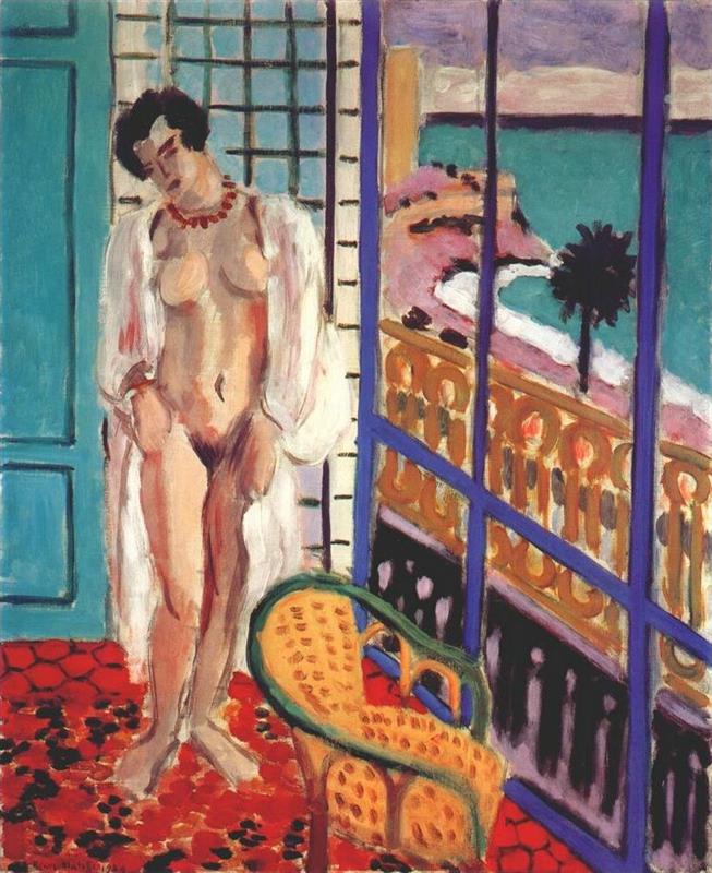 Interior with nude woman standing beside a cobalt-blue balcony door; red hexagonal carpet, turquoise door and gridded screen behind; outside, bands of aqua sea and mauve sky with a dark palm tree; curved wicker chair in foreground and gold balcony railing; Henri Matisse, 1929.