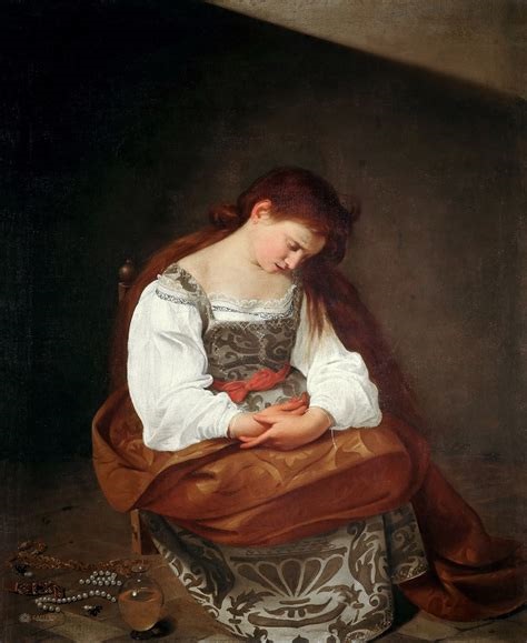 A young woman identified as Mary Magdalene sits in a dim room with head bowed and hands folded, wearing a white chemise and brocaded skirt while jewels and a glass ointment jar lie on the floor beside her, illuminated by soft directional light.