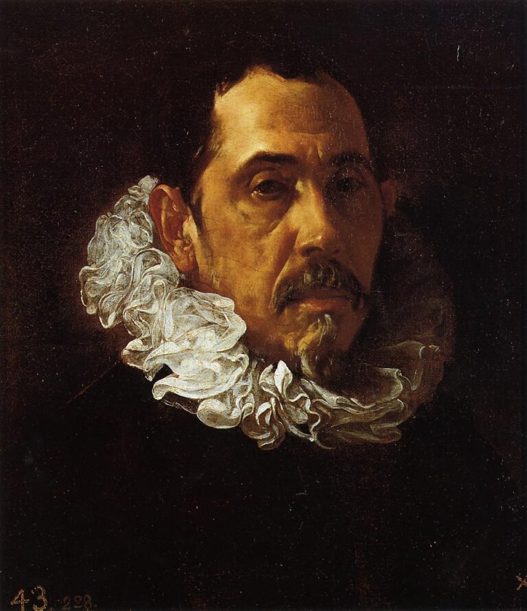 Close portrait of a gentleman in a black costume with a rippling white ruff, his head turned toward the light and a short goatee framing a tense mouth, set against a dark background in Velazquez’s 1622 painting.
