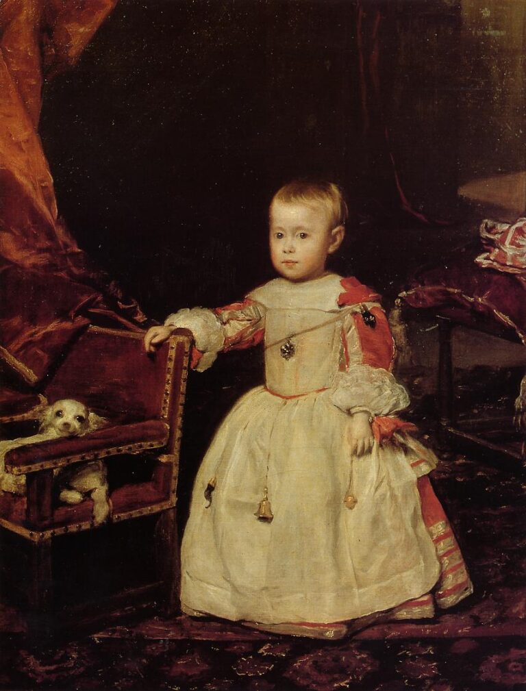 A small boy in pale court dress stands beside a child-sized chair with a little dog peeking out; red drapery and a dark interior surround him as soft light models his face and the gleam of amulets on his chest and sash.