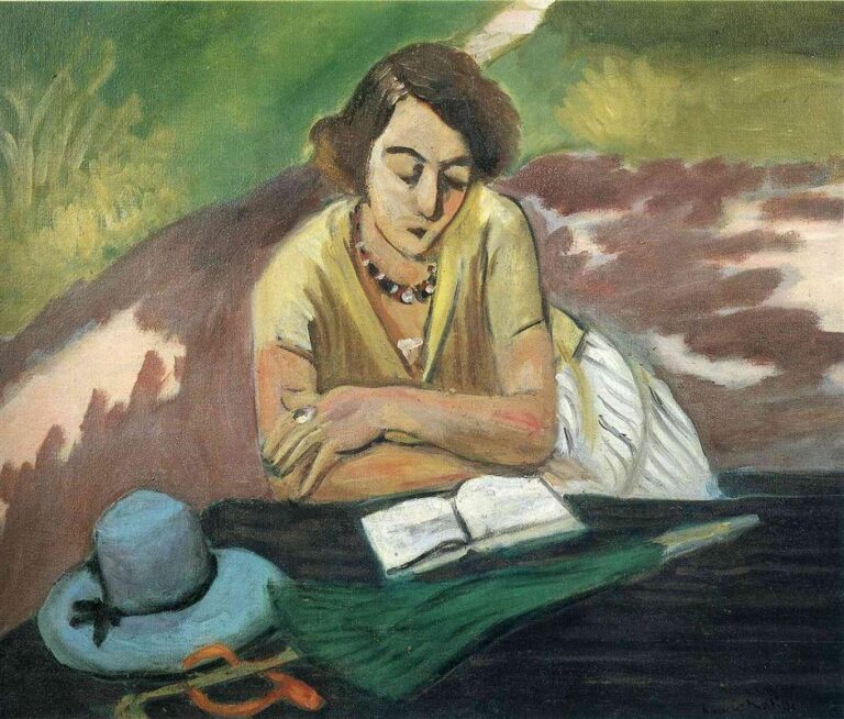 Woman leaning over an open book at a dark table with a light blue hat, amber spectacles, and a green parasol in the foreground; soft green and clay-toned landscape behind; painted in Matisse’s airy Nice-period style.