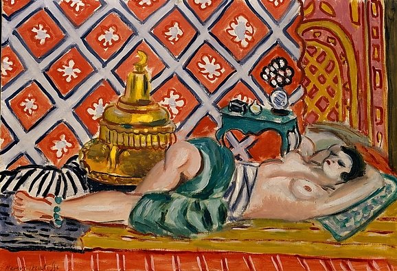 Nude woman reclining on striped floor covering before an orange diamond-patterned wall; turquoise side table with small objects, large gold vessel, zebra cushion, and shallow stage-like space; interior painted by Henri Matisse in 1926.