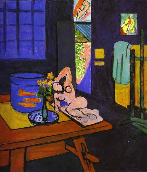 A 1912 interior by Henri Matisse showing a bright orange trestle table with a blue round fish tank of red fish, a small vase of yellow flowers, and a pale reclining sculpture, set in a dark blue room with a window at left, an open doorway to a garden, a turquoise towel on a yellow wall, and an easel at right.