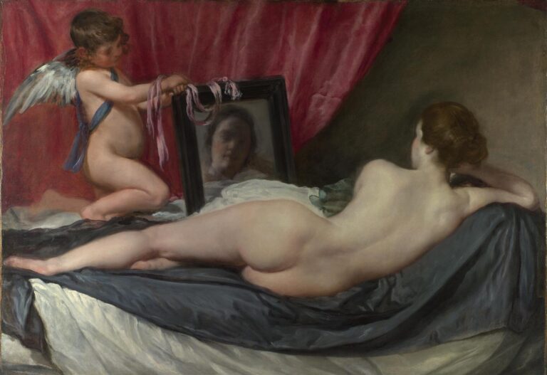 A nude woman reclines on draped fabrics with her back to the viewer while Cupid kneels at the bedside holding a black-framed mirror that shows her soft, blurred face; a crimson curtain and gray bedding frame the intimate scene.