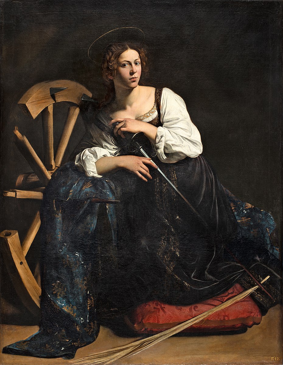A seated young woman identified as Saint Catherine rests on a red cushion, hands folded over a sword in her lap, with a broken spiked wheel behind her and a slim halo above her head; directional light illuminates her face and white sleeves against a dark background.