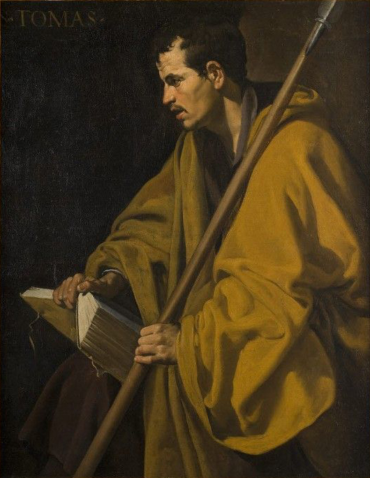 Half-length figure of Saint Thomas in a heavy ocher mantle holding a long spear and a thick book, lit from the left against a dark background; his face in profile is focused and intent, emphasizing inquiry and resolve.