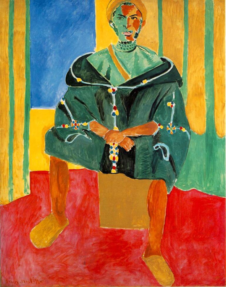 A frontal portrait of a Moroccan man seated on a low block in a red-floored, yellow-walled room; he wears a dark green mantle with beaded ornaments, yellow slippers, and a head covering, with a cool blue wall panel at left. The figure is simplified into bold color planes and strong contours in Henri Matisse’s 1913 style.
