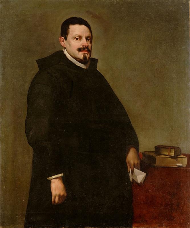 Half-length portrait of Don Sebastián García de Huerta standing beside a red-draped table with books, wearing a black clerical habit and white collar, holding a folded paper as light softly illumines his face against a warm gray background; painted by Diego Velazquez in 1628.