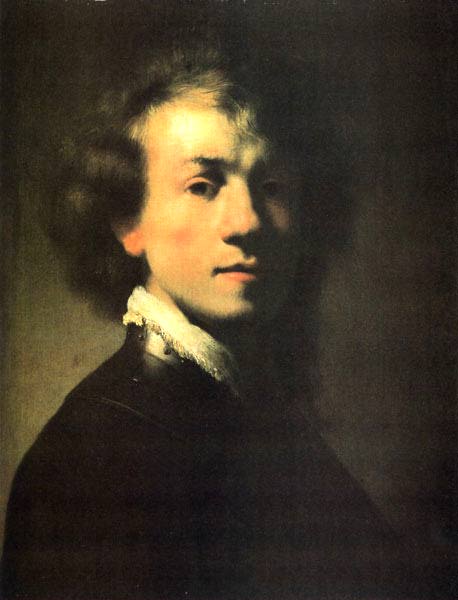 A young Rembrandt turns three-quarters toward the light; his softly glowing face and lace collar emerge from a dark background as curls form a halo and the rest of his body dissolves into shadow.