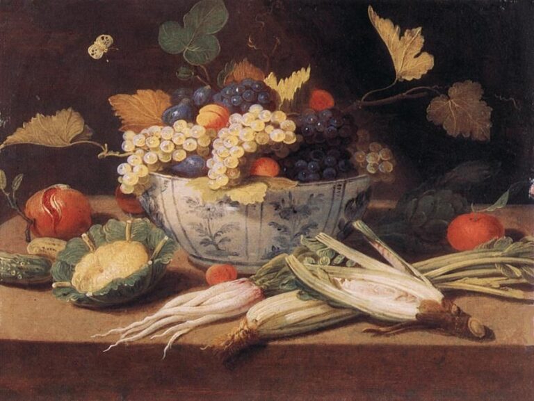 Blue-and-white porcelain bowl overflowing with white and black grapes sits on a stone ledge amid peaches, a green glazed dish with a gourd, endives, spring onions, and a small butterfly against a dark background.