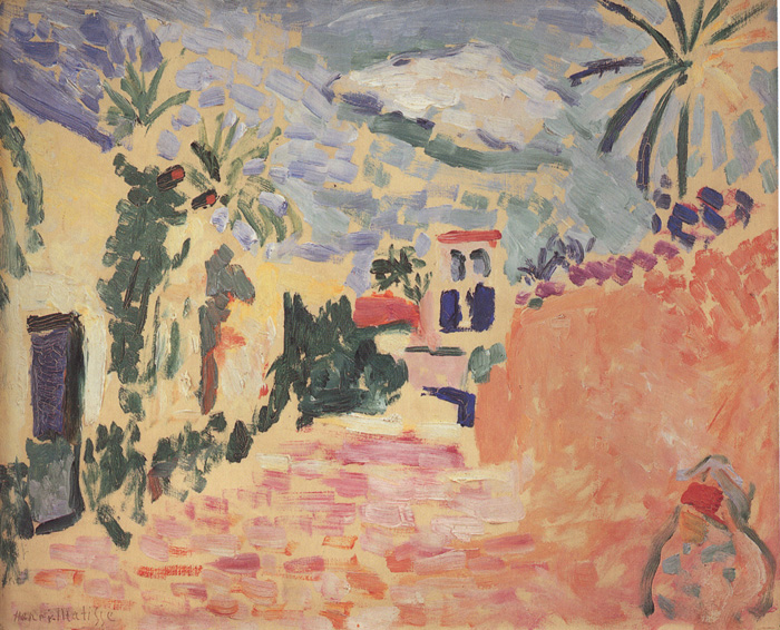 Henri Matisse’s “Street at Biskra” (1906) shows a warm, sunlit street with peach-orange walls, dark green palms, and a small white house with bright blue windows; the paving and sky are built from short lavender, pink, and grey strokes, creating a high-key, Fauvist scene under a broken, hazy sky.