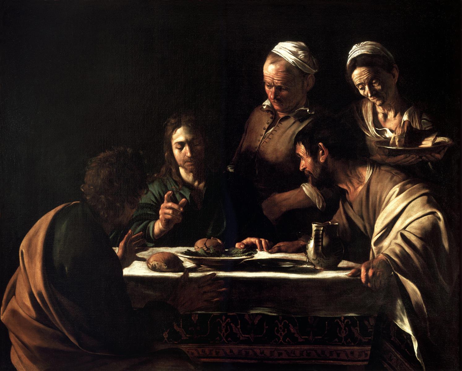 In a dark interior, the risen Christ blesses bread at a small table with two disciples as an innkeeper and a woman look on; strong side light illuminates faces, hands, loaves, a pewter jug, and a plain tablecloth while the background remains in shadow.