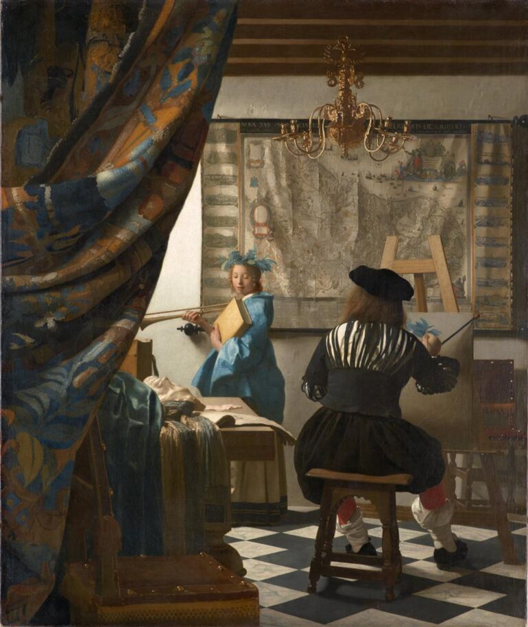 Inside a sunlit Delft studio, a painter seen from behind works at an easel while a young woman dressed as Clio poses with a book and trumpet; a large map hangs on the wall, a gold chandelier glints above, and a patterned curtain is drawn aside over a tiled floor.