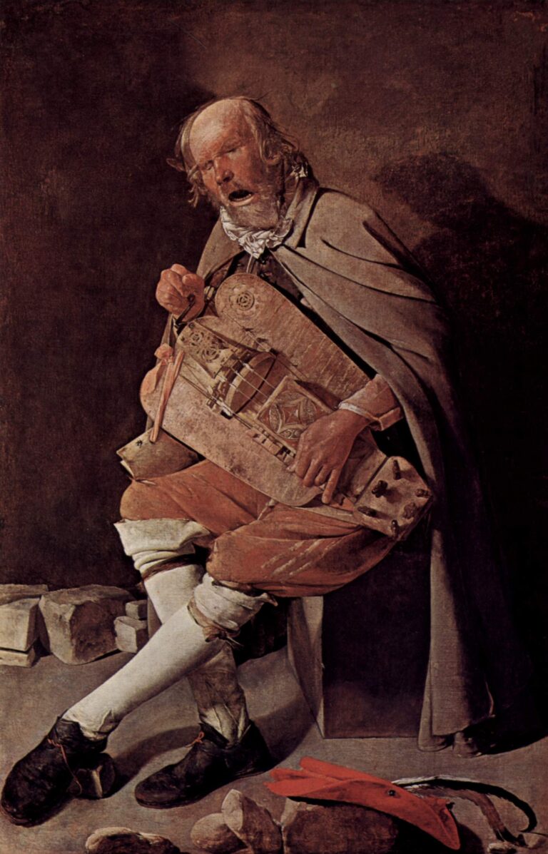 Full-length hurdy-gurdy player sits in a stark corner singing with mouth open, cranking a large instrument held to his chest; a gray cape, red breeches, white stockings, and scattered stones frame the scene while a bright red hat lies on the floor.