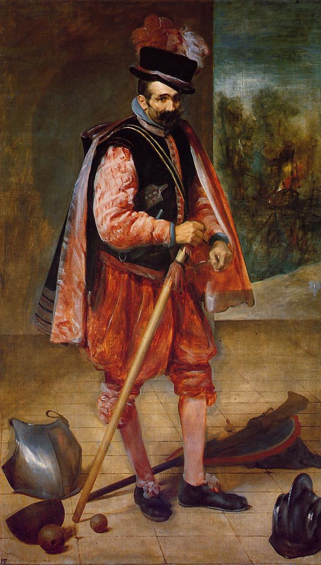 Full-length portrait of a jester dressed in red puffed sleeves and breeches with a feathered hat, leaning on a long staff amid scattered helmet, shield, drumhead, and cannonballs; a smoky battlefield scene appears in a side vista behind him.