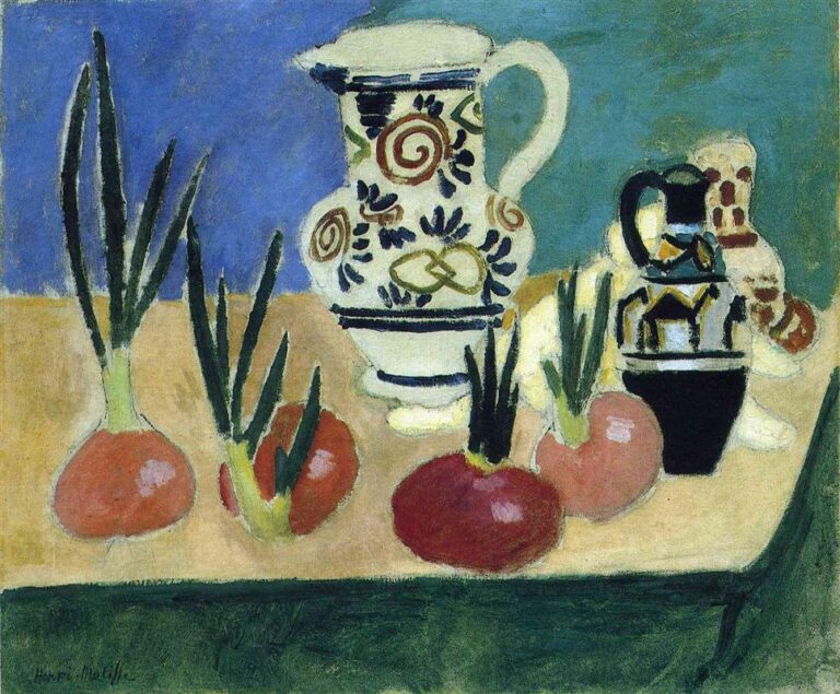 Still life of red onions with green shoots lined across a sandy tabletop; large white jug with spiral motifs at center, smaller black-and-white pitcher to the right, pale ceramic behind; background split into ultramarine and teal; dark green table apron along the bottom; simplified Fauvist forms with dark seams defining edges.