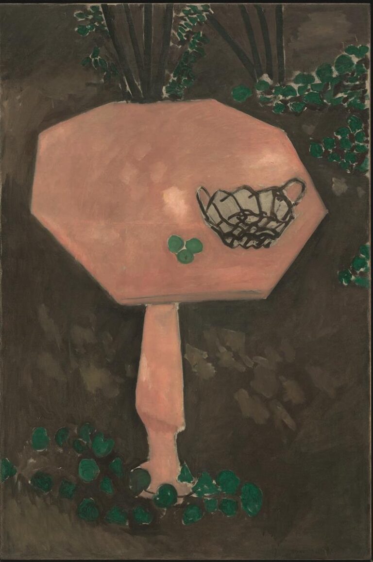 A tall, octagonal rose-pink marble table seen from above stands on a single pedestal over a dark brown ground, ringed by small green leaves; on the tabletop sit a black wire basket and three green fruits, all outlined with decisive black contours.