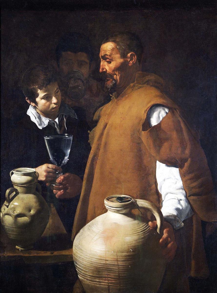 An elderly waterseller in an ocher cloak offers a glass of water to a boy while large clay jars glisten with droplets and a third figure drinks in the background, all illuminated against a dark wall in Velazquez’s “The Waterseller of Seville” (1623).