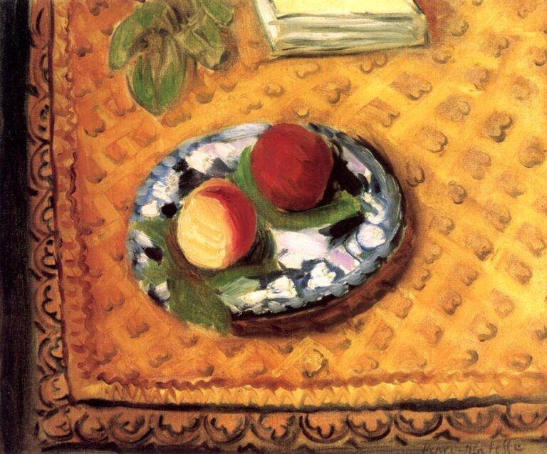 A still life showing two peaches and green leaves on a scalloped blue-white plate set atop a patterned yellow-gold cloth with a dark scrolling border; a closed pale book sits near the top edge.