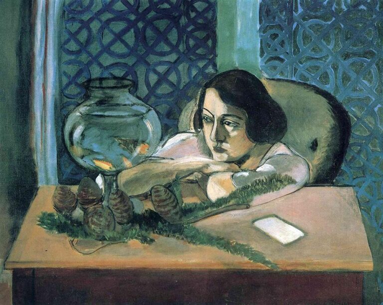A woman leans on a table with arms crossed, gazing at a round glass bowl containing orange goldfish; a garland with small cones lies across the tabletop beside a pale card; behind her are deep blue patterned curtains and a cushioned chair, all painted with soft Nice-period light.