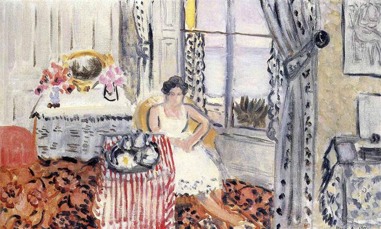 Interior scene of a woman in a white dress seated beside a small table with a red-and-white striped cloth and tea service; pink flowers and an oval mirror sit on a side table, patterned curtains frame a window, and a red arabesque carpet fills the floor.