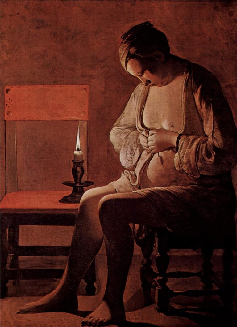 Candlelit interior with a seated woman bending over her lap to pinch a flea; an empty chair and small candlestick flank her, warm light modeling bare shoulder, breast, and linen folds against a plain reddish wall.