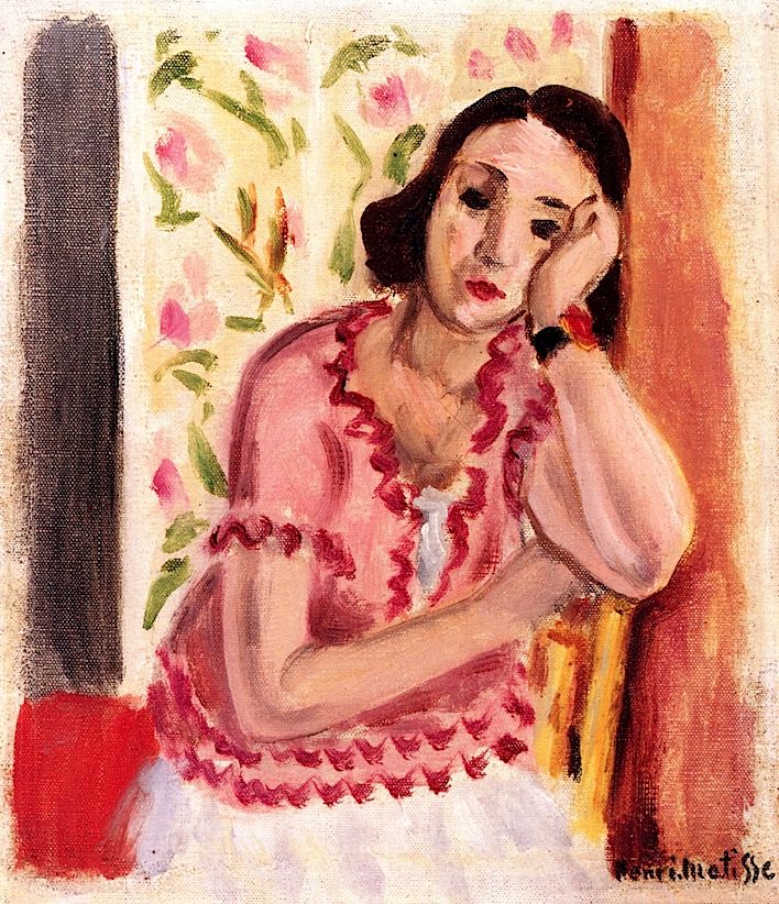 A woman in a pink ruffled blouse sits with her head resting on her hand, gazing downward, framed by floral wallpaper and warm vertical bands in an intimate interior painted with soft, luminous strokes.