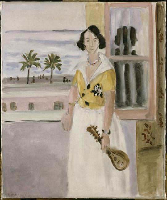 Standing woman in yellow blouse and white skirt holding a small mandolin near an open window; to the left the promenade with palm trees and a layered blue sea; a yellow window jamb and rose shutter frame the view; simplified forms and soft Mediterranean light characteristic of Matisse’s Nice period.