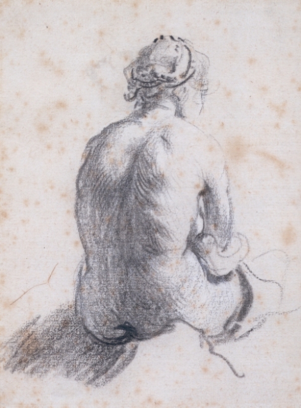 Chalk drawing of a seated female nude viewed from the back, head slightly turned right; soft contours and shaded planes describe shoulders, spine, and hips, with a dark ground patch anchoring the figure against the light paper.
