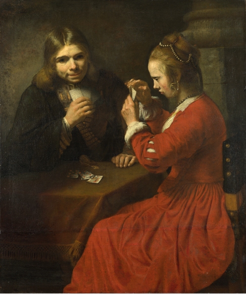 Two figures seated at a small table under warm light: a young man in dark clothing holding a glass watches a girl in a red dress as she studies her cards; a few cards lie on the table within a dim tavern-like interior.