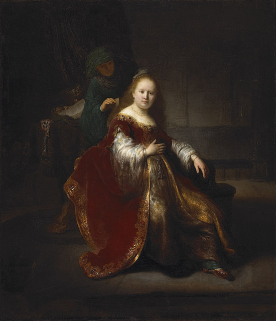 Rembrandt painting of a richly dressed young woman seated during her toilette, illuminated by warm light as an attendant stands in shadow behind her within a dim interior.