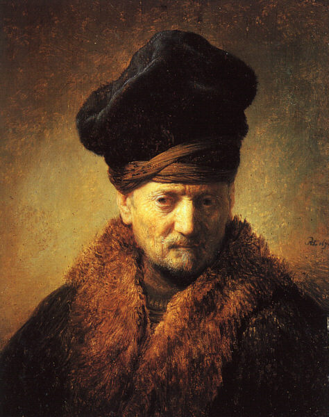 Head-and-shoulders portrait of an elderly man wearing a large dark fur cap and thick fur collar; warm light strikes his brow and cheek as he looks downward, set against a golden-brown background in Rembrandt’s rich chiaroscuro.
