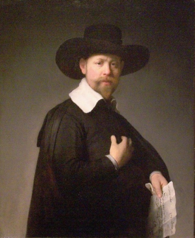 Half-length portrait of a man in a wide black hat and black cloak with a white collar, one hand resting on his chest and the other holding a folded paper, turning three-quarter toward the viewer against a plain gray background.