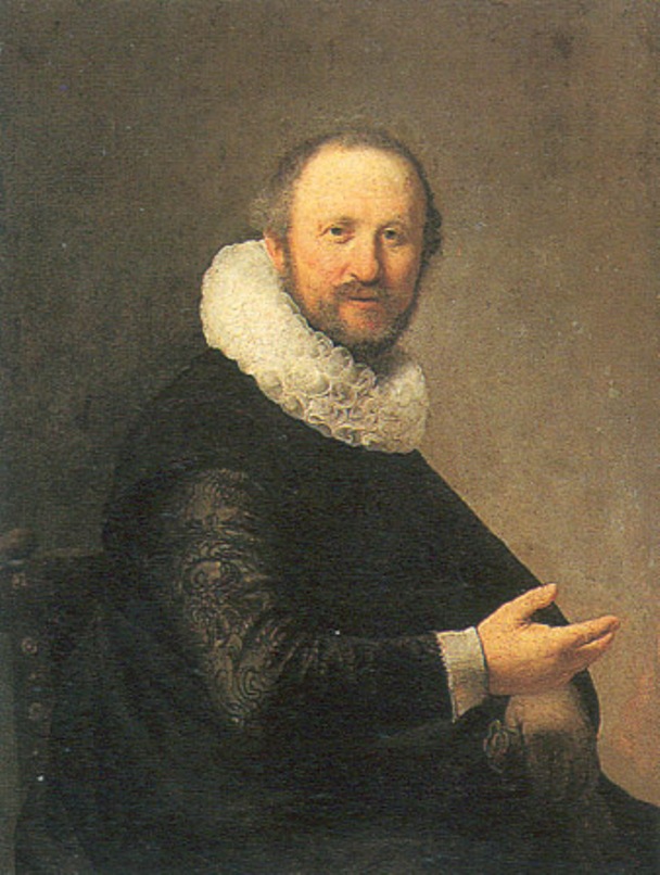 A middle-aged man sits three-quarter to the right wearing a dark garment with a patterned sleeve and a bright millstone ruff; his right hand opens in a gentle gesture while his face, warmly lit against a neutral background, gazes calmly toward the viewer.