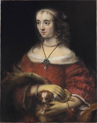 Rembrandt portrait of a young woman in a red gown and pearls, softly lit against a dark background, holding a small spaniel across her forearms; jewels and lace glimmer while warm skin and fur create an intimate, dignified scene.