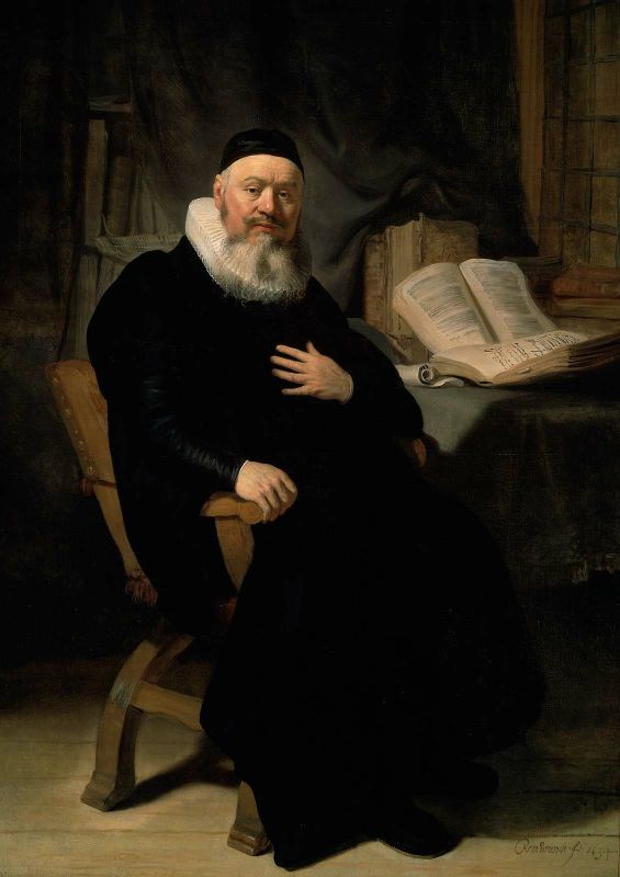 Seated half-length portrait of minister Johannes Elison in black robe and white ruff, hand on chest beside a table with open folio books, softly lit within a study, painted by Rembrandt in 1634.